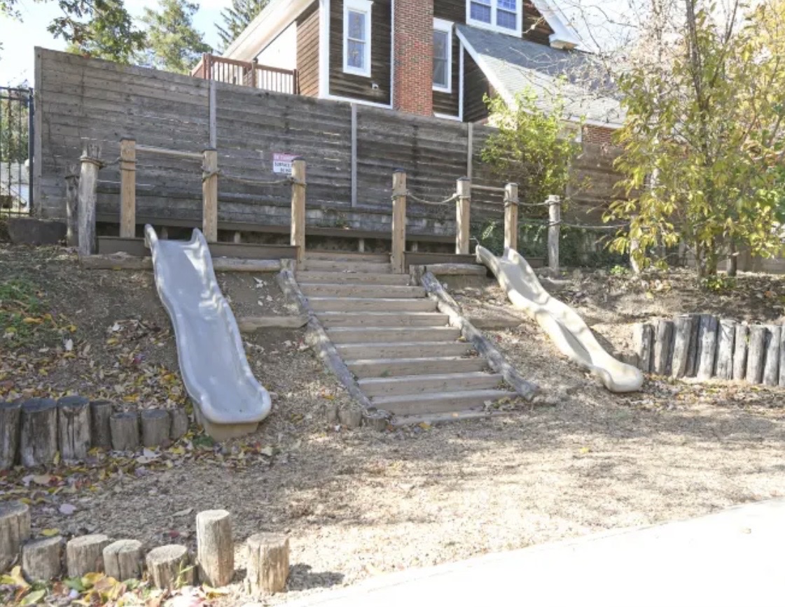 Outdoor play area with dual slides